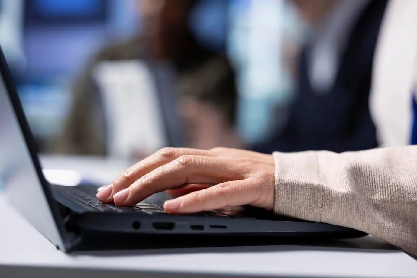 Factory shareholder typing on a laptop while monitoring system performance